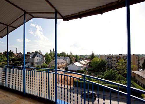 a balcony with a view of a city at Pokoje Horyzont in Jarosław