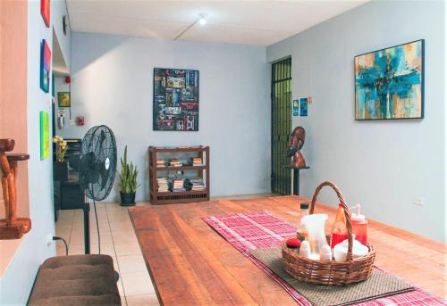 a living room with a basket on the floor at Eventuality B&B New Kingston in Kingston