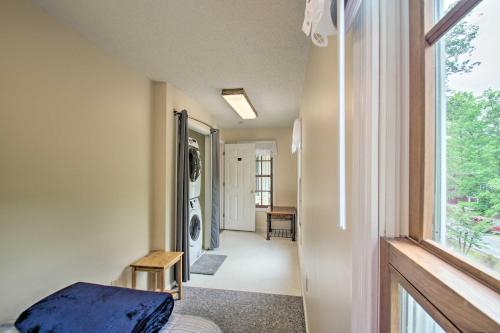 a room with a bed and a hallway with a window at 17-Seat Theater, Hot Tub and Game Room Ideal Home! in Massanutten