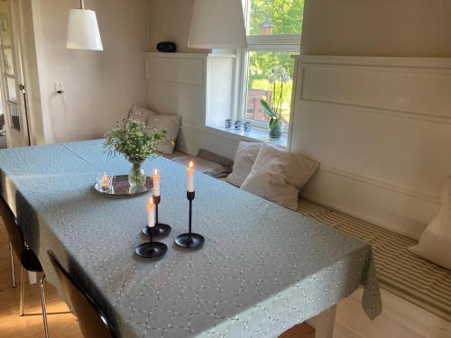 a dining room table with candles on top of it at Residens Svalhøj in Hasle