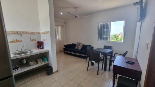 a kitchen and living room with a table and a couch at A una calle del ado 5ta avenida in Playa del Carmen