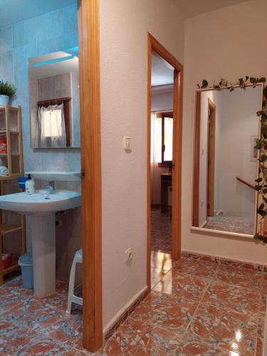 a bathroom with a sink and a mirror at Casa Valentino in Santa Pola