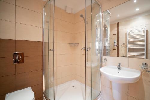 a bathroom with a shower and a sink at Villa Luka in Łeba