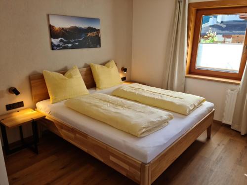 a bedroom with two beds and a window at Chalet Marie in Finkenberg