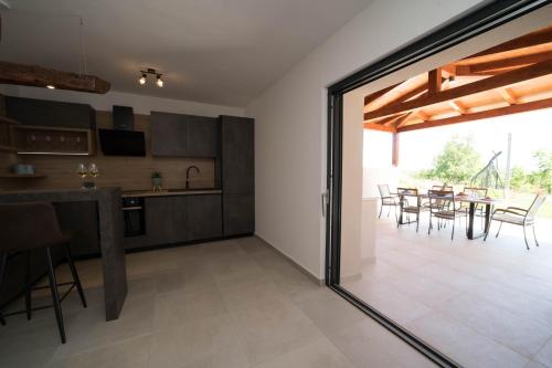 a kitchen and dining room with a table and chairs at VILLA FIORE in Marušići