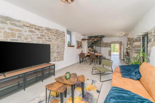 a living room with a large flat screen tv at VILLA FIORE in Marušići