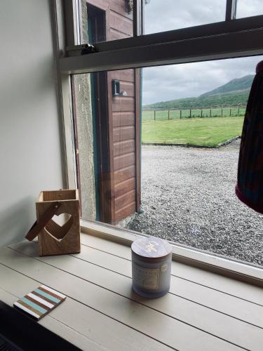 a window looking out at a view of a field at Quirky Highland Cottage with Stunning Views in Wester Fearn