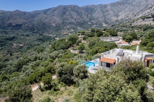 an image of a villa with a swimming pool and mountains at Villa Asigonia with Heated Pool & Whirlpool in Asigonía