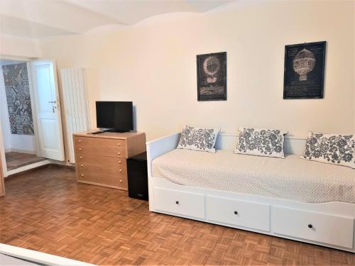 a bedroom with a bed and a tv on a dresser at Camere Urbevetus in Orvieto