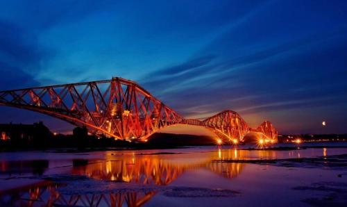 a large red bridge over a river at night at 4 bed bungalow near Airport in Edinburgh