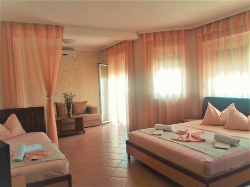 a hotel room with two beds with towels on them at Apartmants Elisa in Ulcinj