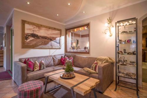 a living room with a couch and a table at Hotel Landhaus Zillertal in Fügen