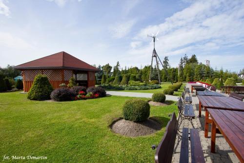 a park with a windmill and a bench and a windmill at Domki Ania in Łeba