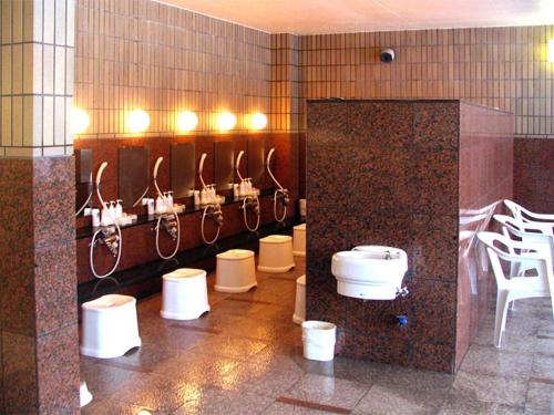 un baño con un montón de lavabos y aseos en Kitami Pierson Hotel - Vacation STAY 54802v, en Kitami