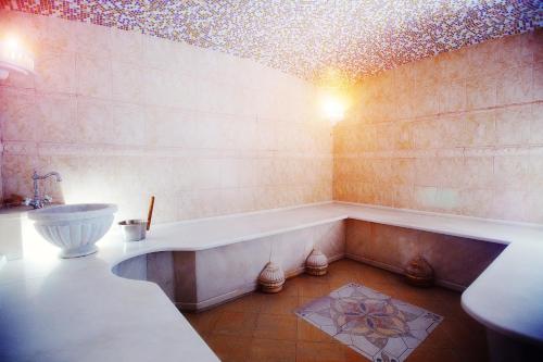 a bathroom with a tub and a sink at Park Hotel Berezka in Chelyabinsk