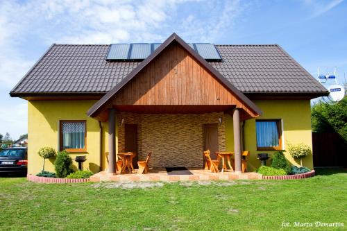 a house with solar panels on top of it at Domki Ania in Łeba