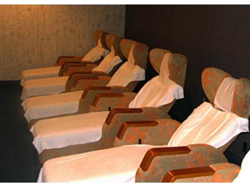 a row of beds lined up in a room at Kitami Pierson Hotel - Vacation STAY 54782v in Kitami