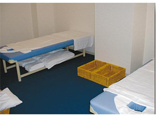 a hospital room with two beds and a yellow box at Kitami Pierson Hotel - Vacation STAY 54782v in Kitami