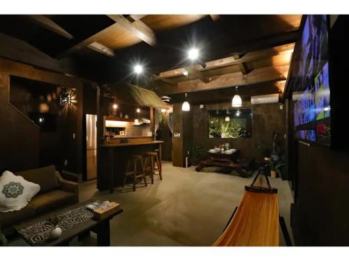 a living room with a couch and a bar at east village torami - Vacation STAY 65943v in Ichigaya