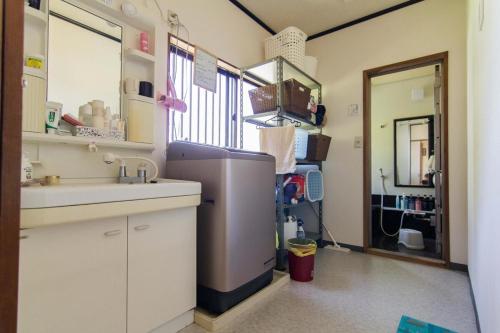 a kitchen with a sink and a refrigerator at Siawase no yado - Vacation STAY 68283v in Fuefuki