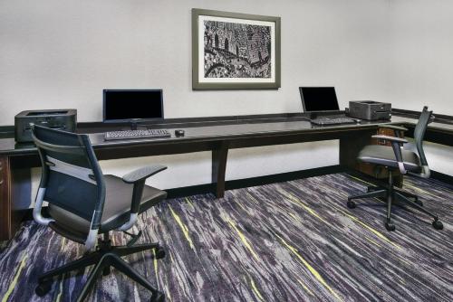 an office with a desk with two computers and two chairs at La Quinta Inn & Suites by Wyndham San Antonio Riverwalk in San Antonio