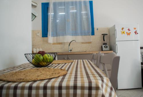 a kitchen with a table with a bowl of fruit on it at SOLE E MARE in Elafonisos