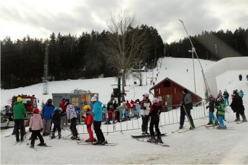 a group of people on skis in the snow at Cozy rustical house in the highland (entire place) in Kožlí