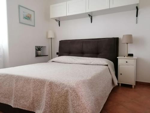 a bedroom with a large bed with a black headboard at PERLA DEL GOLFO (con Box Auto) in Lerici