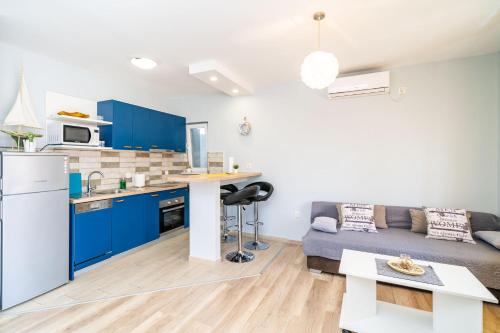 a kitchen and living room with blue cabinets and a couch at Dubrovnik dream by Nostromo in Dubrovnik