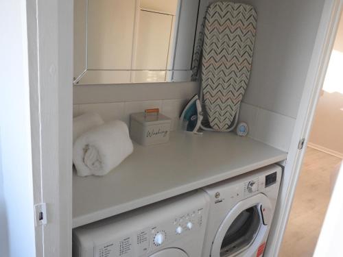 a laundry room with a washer and dryer at Serviced Accommodation in Hull