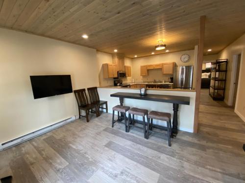 a kitchen and living room with a table and chairs at Hotel Ouray - for 12 years old and over in Ouray