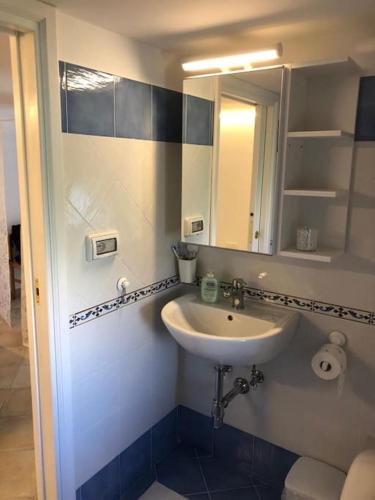 a bathroom with a sink and a mirror at Lilli's House in Capri in Capri