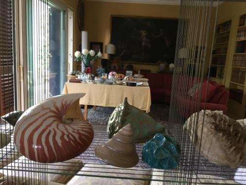 a living room with a table and some pillows at B&B La Villa Mediterranea in Passirano