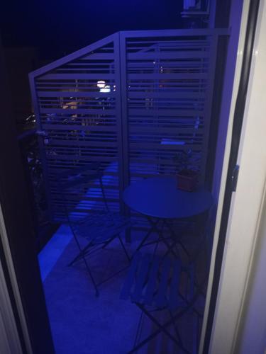 a room with a table and chairs on a balcony at night at Il Paradiso di Marilyn in Milazzo