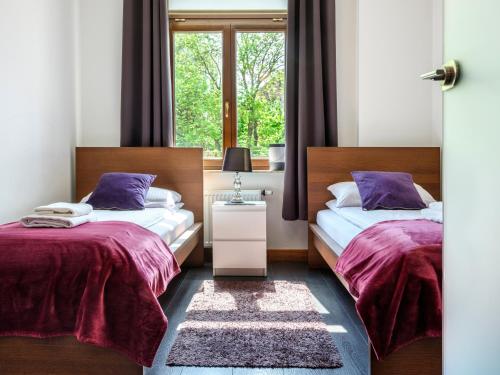 2 letti in una camera con finestra di CracWoW VIP Apartment a Cracovia