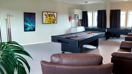 a living room with a pool table and a couch at Kiruna City Room in Kiruna