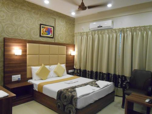 Säng eller sängar i ett rum på Hotel Aditya