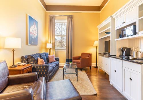 a living room with a couch and a table at Inn at Diamond Cove in Portland