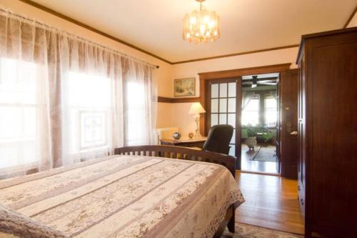 a bedroom with a bed and a chair and a window at Victorian Condo in Boston