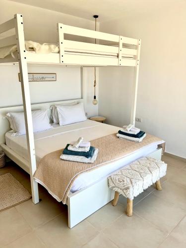 two bunk beds with towels on them in a room at Villa Estée, luxury villa with private infinity pool and jacuzzi in Elounda
