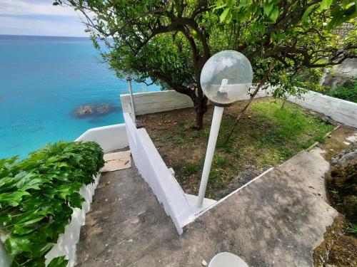 a cross on a pole next to the ocean at Villa Paradise (Amalfi Coast - Luxury Home - Beach) in Vietri sul Mare