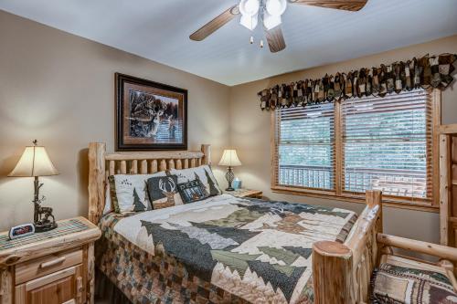 a bedroom with a bed and a ceiling fan at Oasis In the Mountains in Murphy