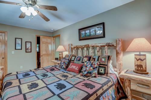 a bedroom with a bed and a ceiling fan at Oasis In the Mountains in Murphy