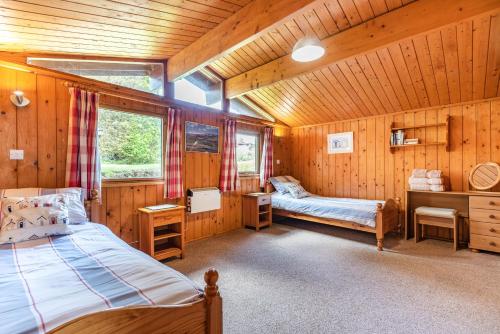 a bedroom with a bed in a wooden cabin at Pentref in Aberdyfi