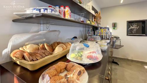 a bakery with bread and pastries on a counter at Khan Duidar Inn - Pyramids View Rooftop in Cairo