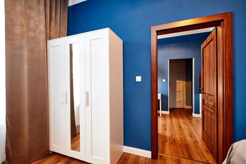 a room with blue walls and a white door at Residence Vaclavska in Prague