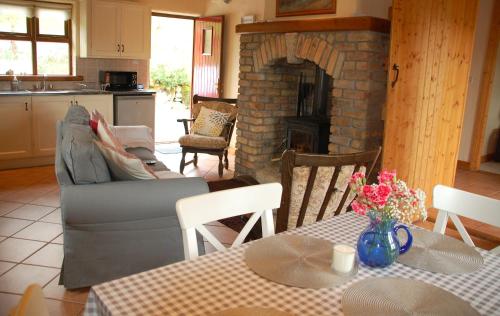 sala de estar con sofá y chimenea en Corriebrack cottage, en Hollywood