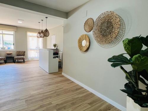 a living room with white walls and wooden floors at Hostal Eden in Sanxenxo