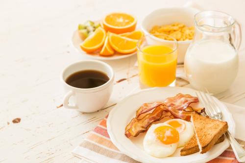 a plate of breakfast food with eggs and toast at El Morro Eco Adventure Hotel in San Fernando de Monte Cristi