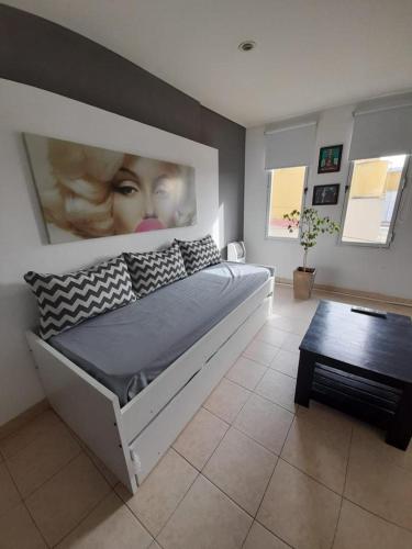 a bedroom with a large bed with a poster of a woman at FINCA NOVA Apartment 6 in Balcarce